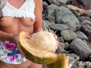 Naked girl found a coconut first of all a public beach and poured the juice over her body